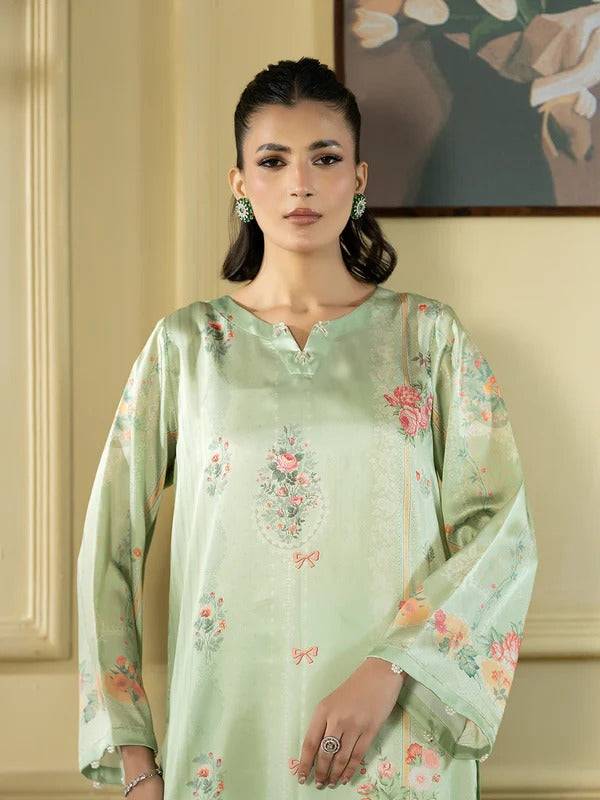 Close-up of woman in silk 2-piece with floral embroidery, indoor background