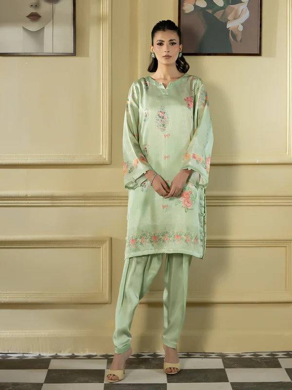 Full-length view of woman in silk 2-piece with floral embroidery, standing indoors