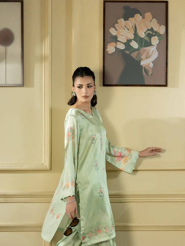 Side profile of woman in silk 2-piece with floral embroidery, indoor setting