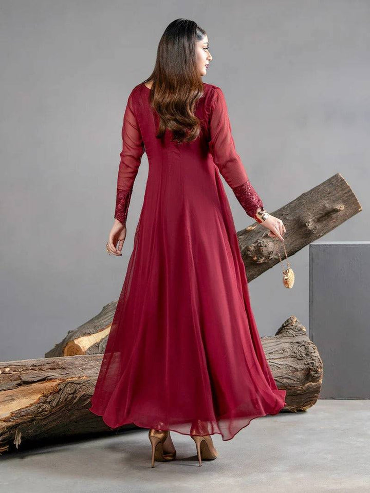 Back view of maroon chiffon dress with flowing skirt