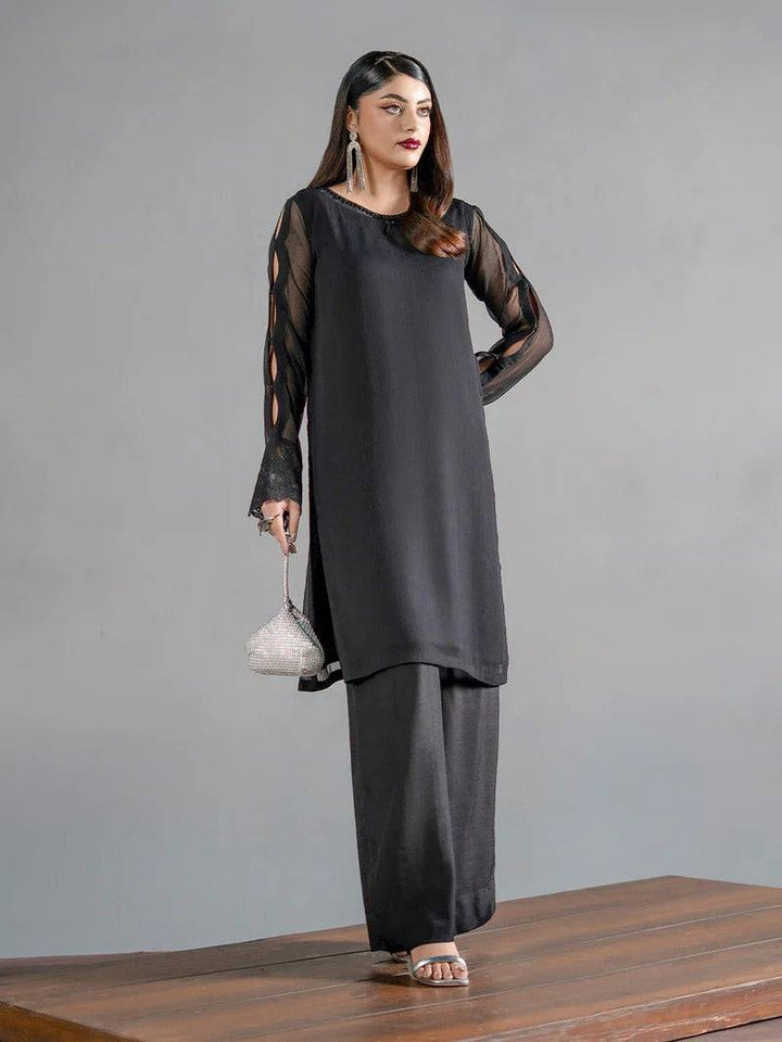 Elegant black chiffon kurta with sheer cutout sleeves and matching trousers