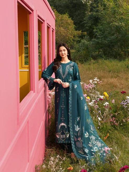 Model in teal embroidered kurta with floral dupatta outdoors