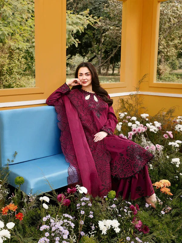 Model sitting on blue bench with maroon kurta and floral garden background