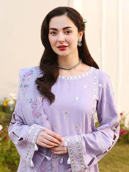 Front view of woman in lilac embroidered traditional dress with jewelry