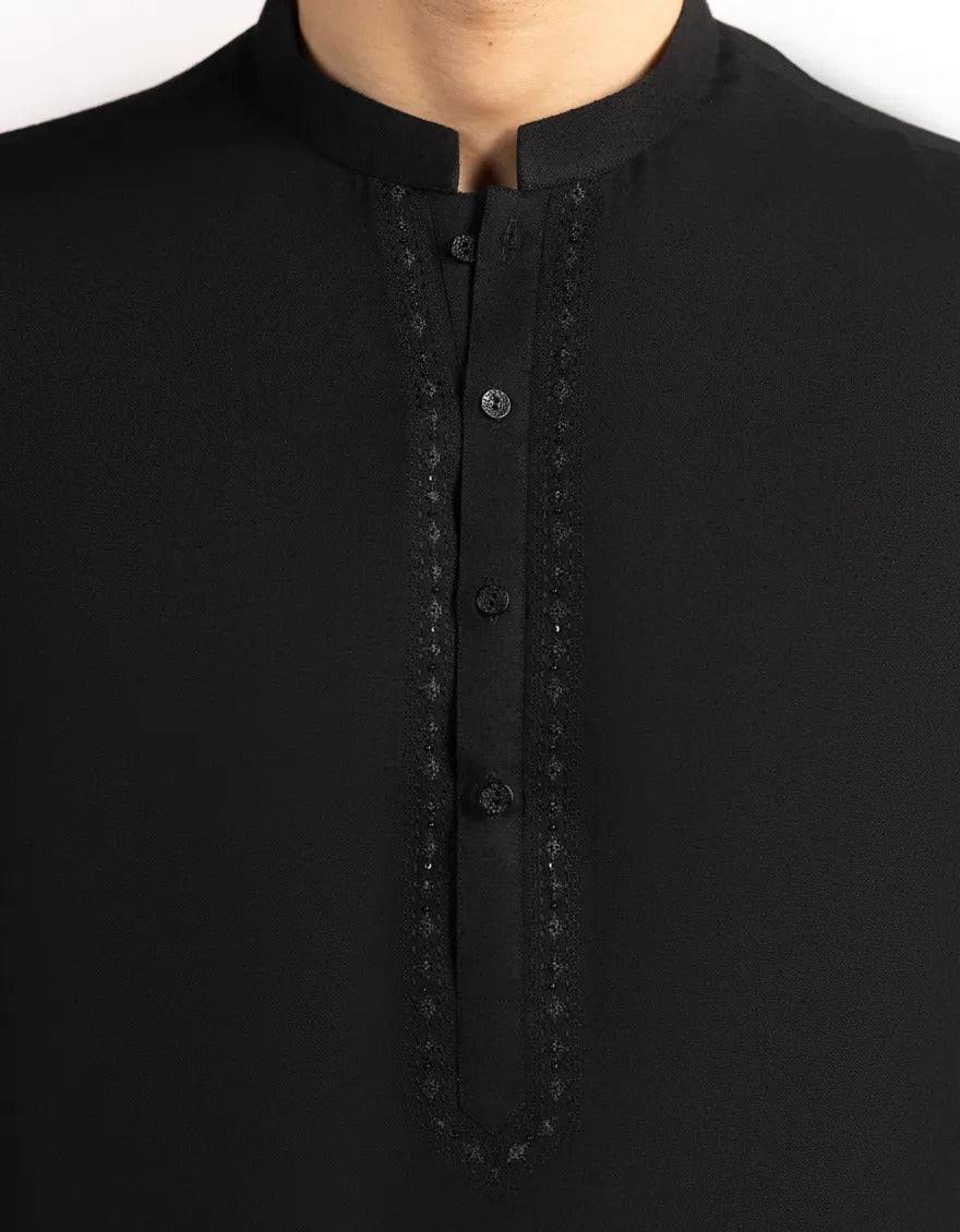 Close-up of black kurta's button placket with embroidery detail