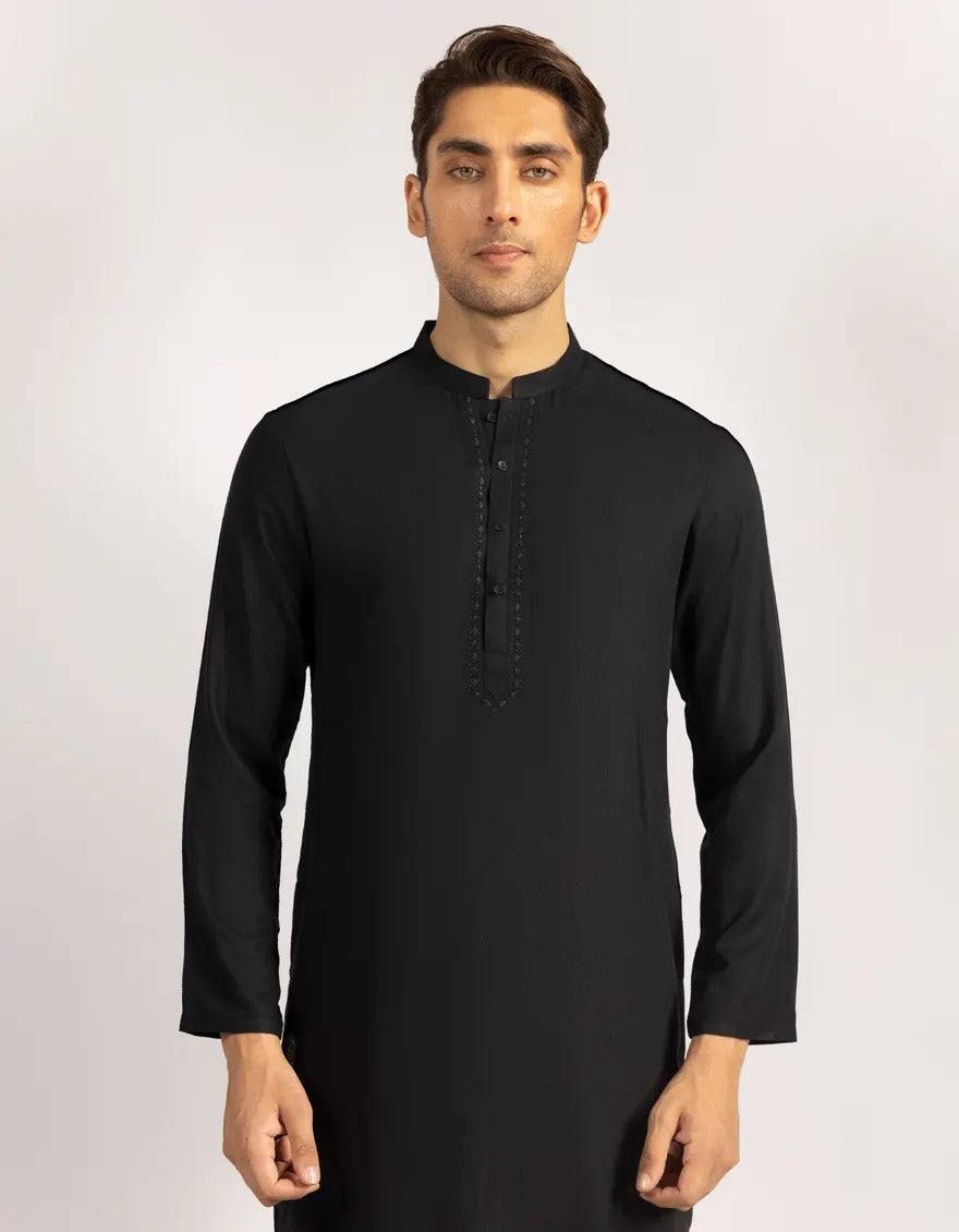 Model wearing black semi-formal kurta with cream trousers, showcasing versatile apparel for semi-formal occasions