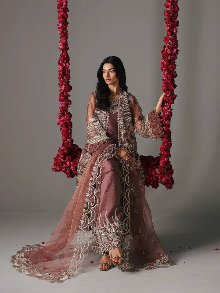 Close-up of model in maroon embroidered sharara with jewelry for festive occasion