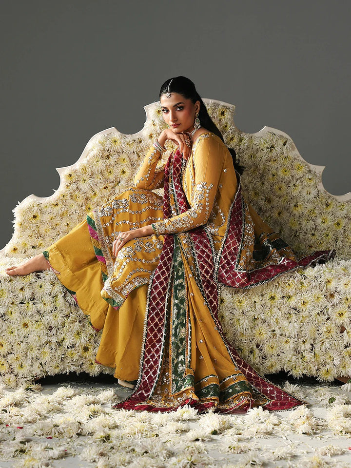 Model sitting in yellow embroidered sharara suit with dupatta, festive wear, clothing category