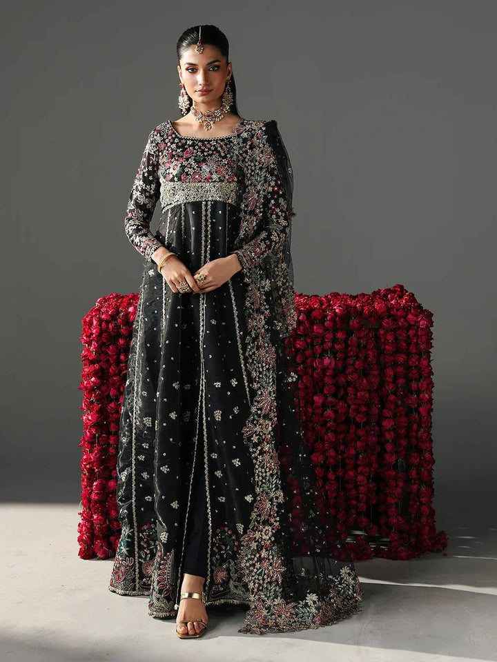 Black embroidered traditional dress with floral and intricate embroidery, model wearing jewelry, festive attire