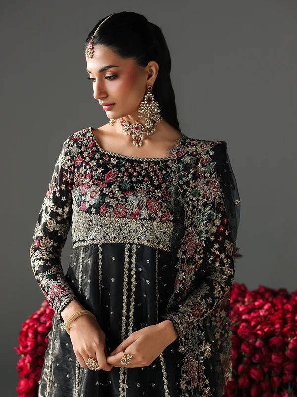 Black embroidered traditional dress with floral and intricate embroidery, jewelry, and accessories