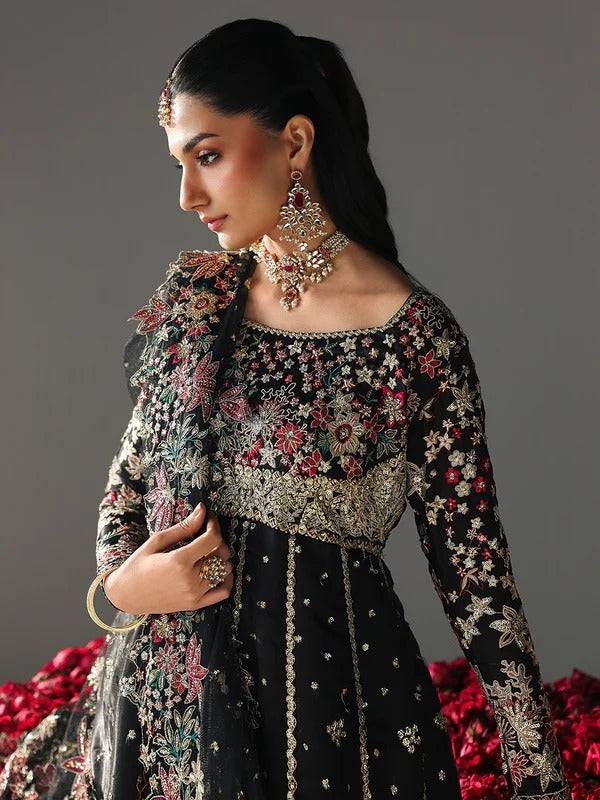 Black embroidered dress with floral embroidery, jewelry, and accessories for festive wear