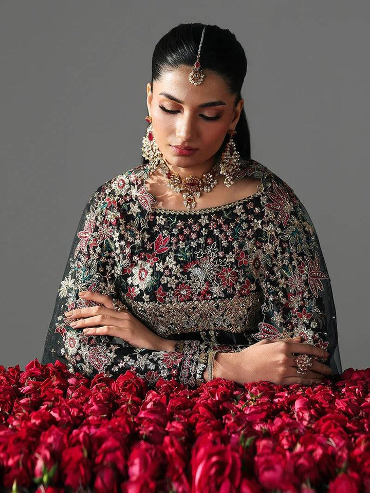 Black embroidered dress with floral embroidery, jewelry, and accessories for festive occasions