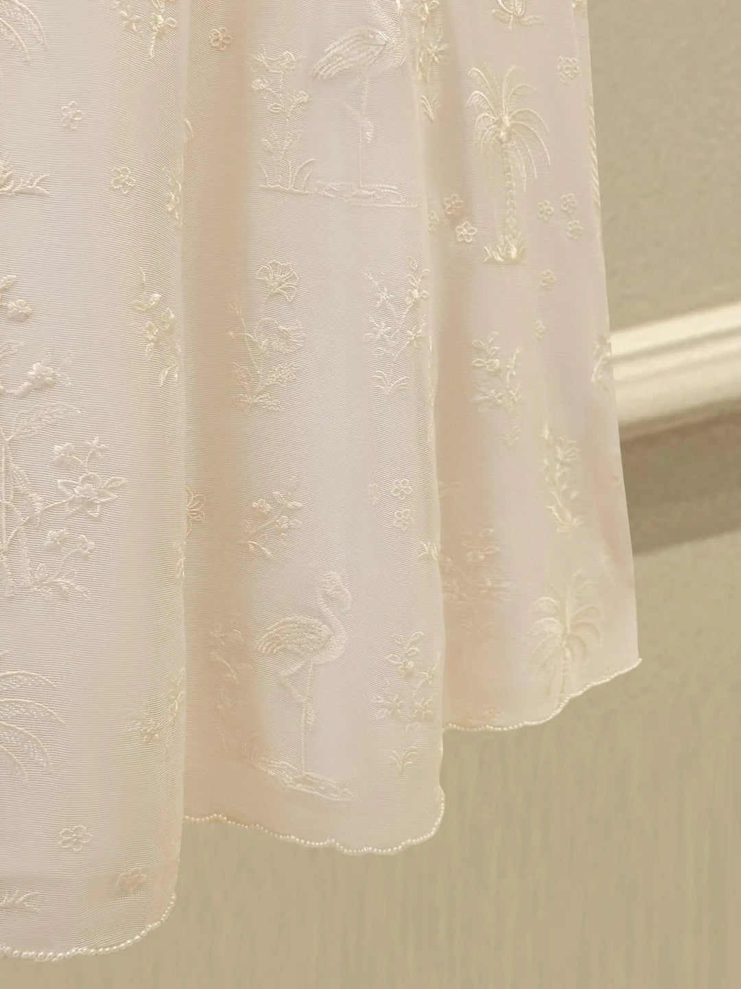 Hemline of AGHA NOOR Cotton Net Suit - Pakistani Embroidered | 3 Pc adorned with flamingo and floral embroidery in soft white thread.