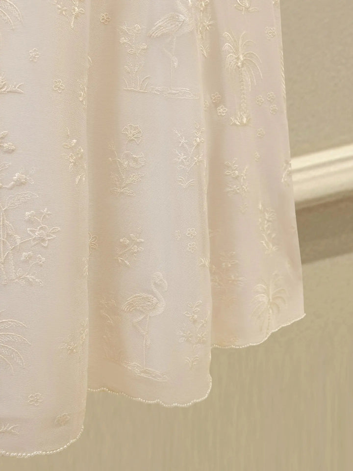 Hemline of AGHA NOOR Cotton Net Suit - Pakistani Embroidered | 3 Pc adorned with flamingo and floral embroidery in soft white thread.