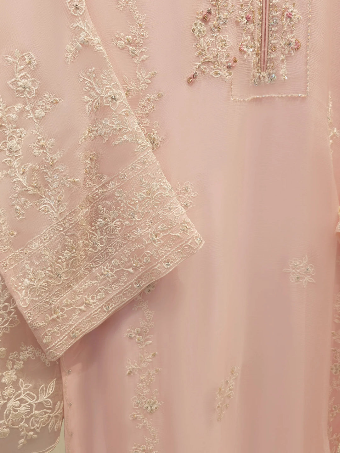 Detailed sleeve embroidery of AGHA NOOR Embroidered Chiffon Suit - Dress showcasing fine craftsmanship on the pink chiffon shirt.