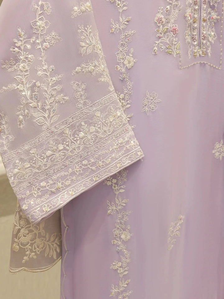 Sleeve embroidery detail of AGHA NOOR Chiffon Suit, showcasing intricate white floral patterns on lilac chiffon fabric.