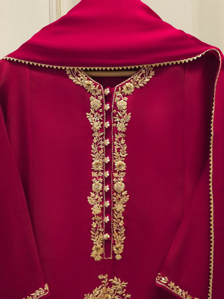 Close-up of AGHA NOOR embroidered neckline featuring intricate gold floral threadwork on cotton net fabric for elegant Pakistani fashion.