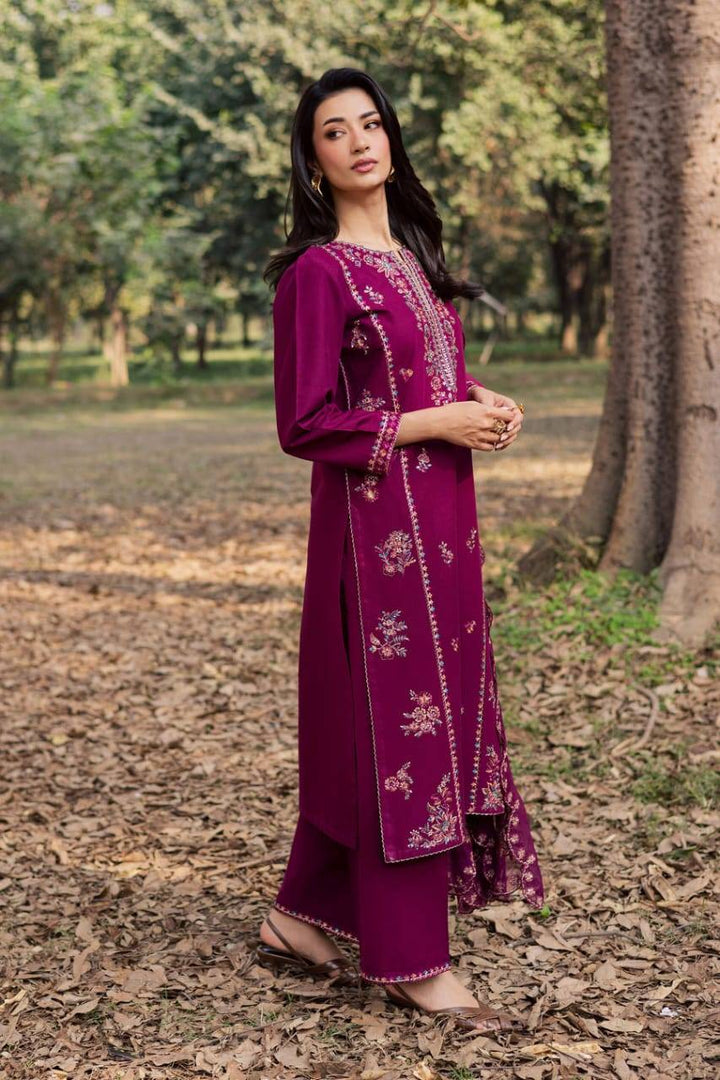 Side pose of model in BATIK Sole 3Pc embroidered Khaddar dress highlighting side embroidery and stylish silhouette for women’s fashion.