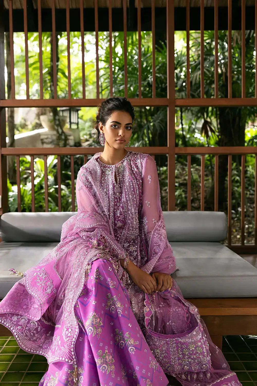 Model seated in LIYANA-SRF25-07 Saira Rizwan Luxury Pink outfit, highlighting the elegant tailoring and traditional embellishments.