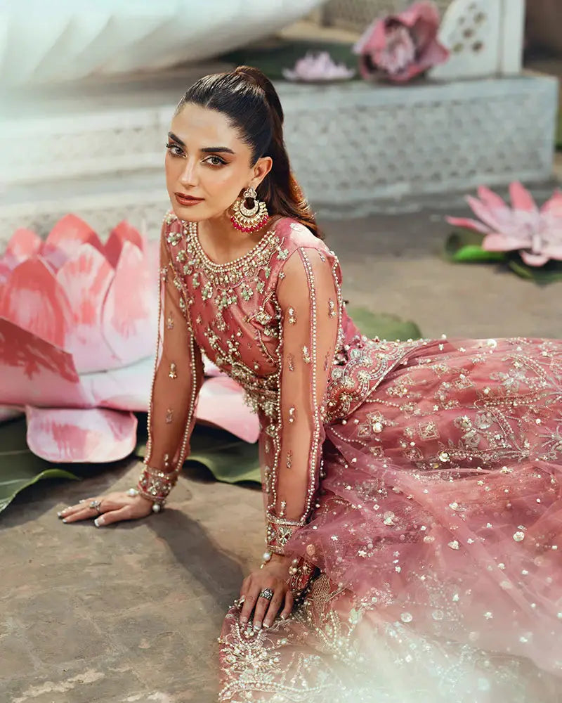 Close-up seated view of AR-142 ZORA coral pink wedding dress showcasing 3D floral embroidery and net fabric with pearl accents.