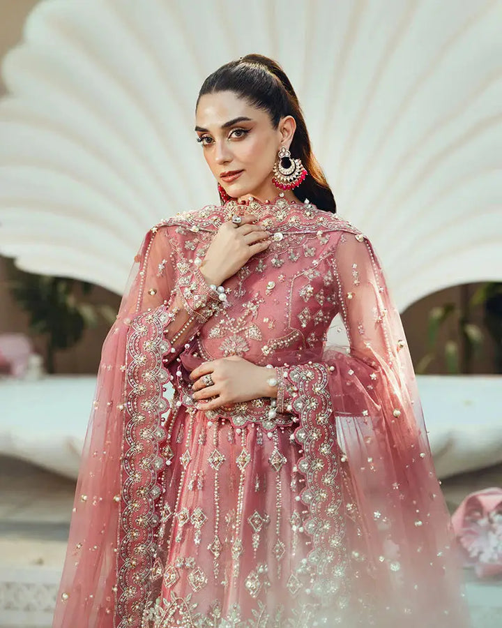 Model in AR-142 ZORA coral pink wedding ensemble with embellished dupatta and detailed embroidery, perfect for formal occasions.