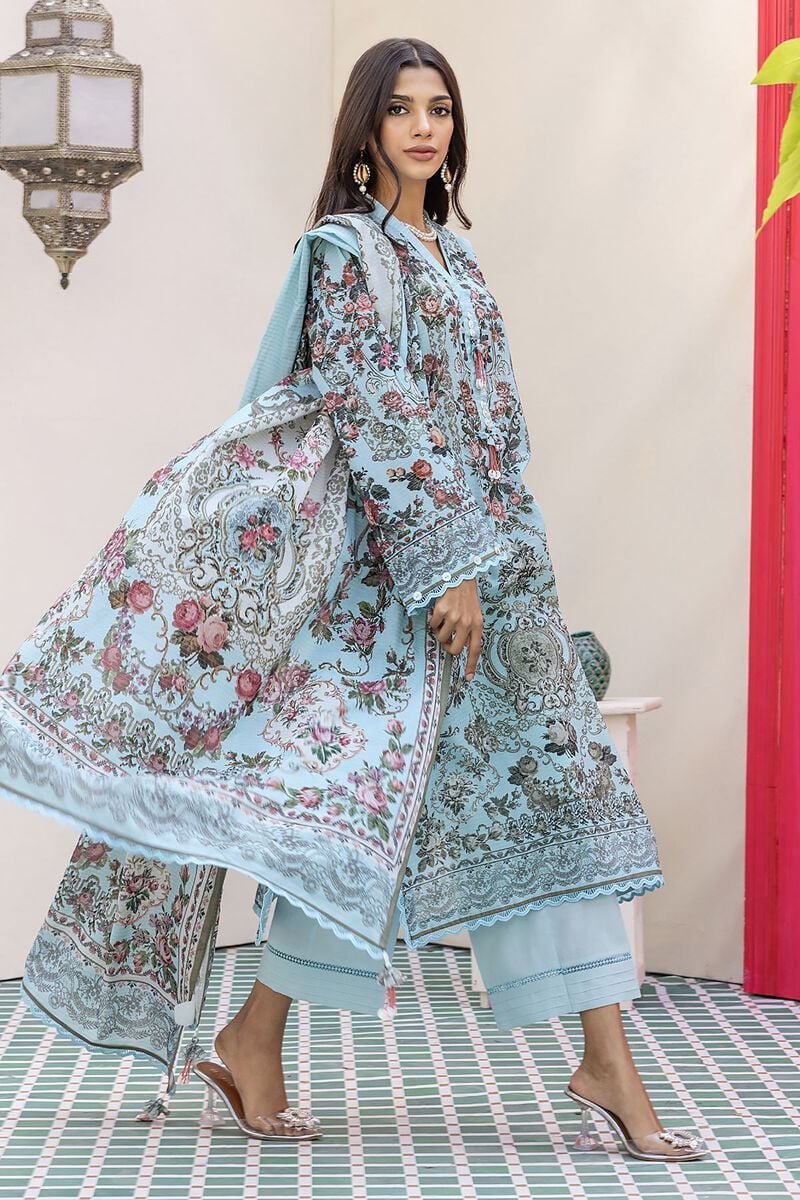 pakistani dresses online usa a woman in a blue dress standing on a tiled floor