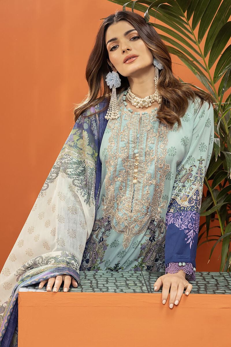 pakistani outfits usa a woman in a blue dress sitting on a bench