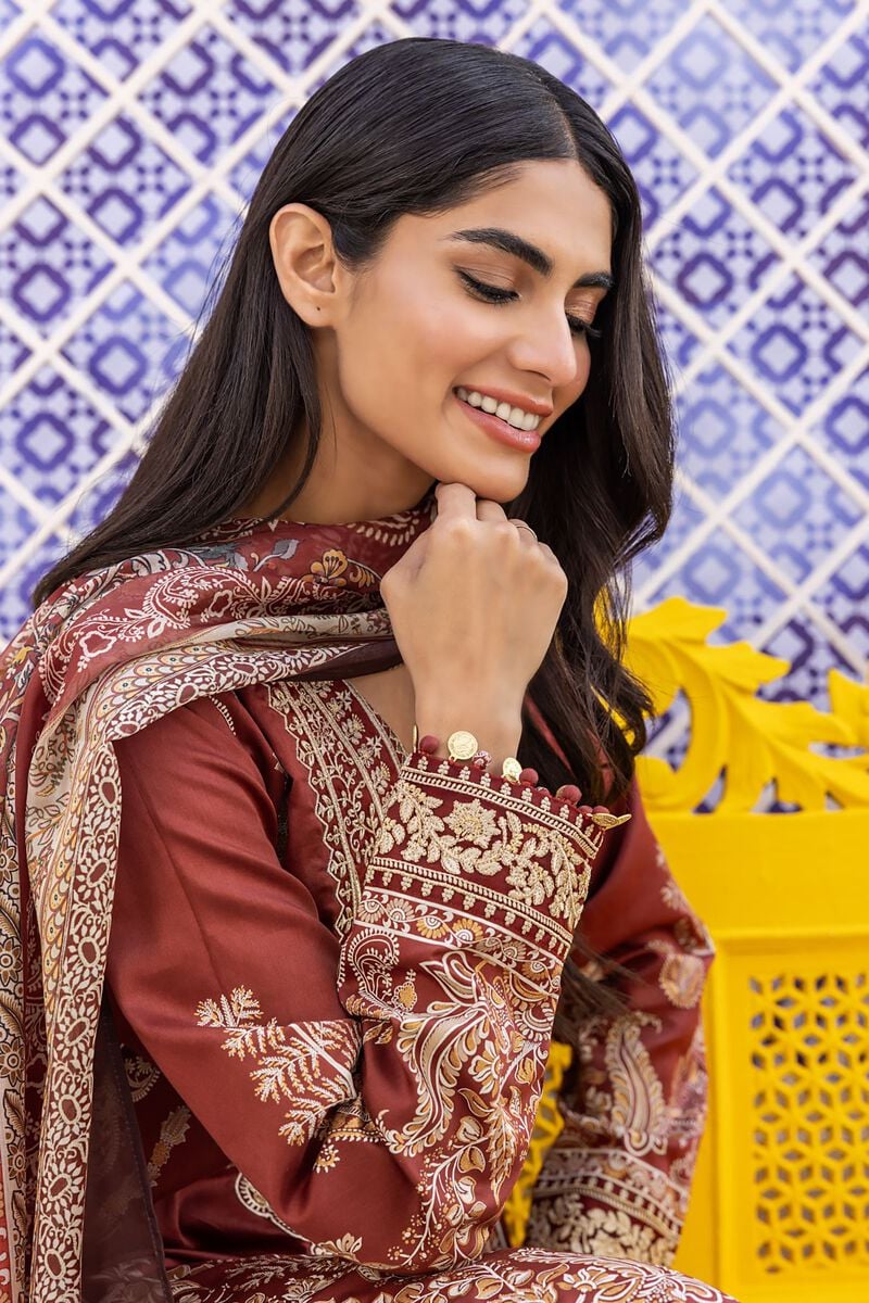 Dupatta Shalwar Kameez a woman sitting on a yellow bench wearing a red and gold dress
