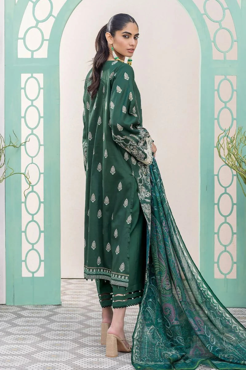 pakistani casual clothes a woman in a green dress standing in front of a wall