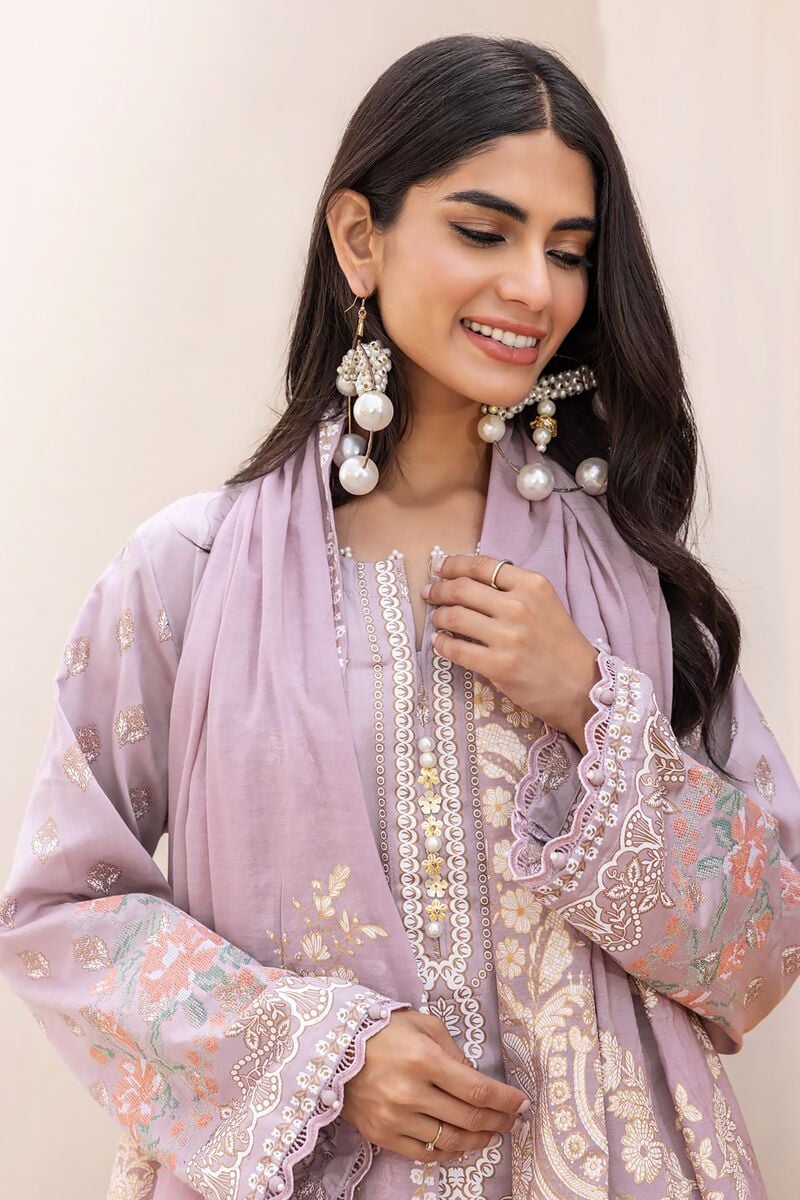 pakistani outfits usa a woman wearing a purple dress and earrings