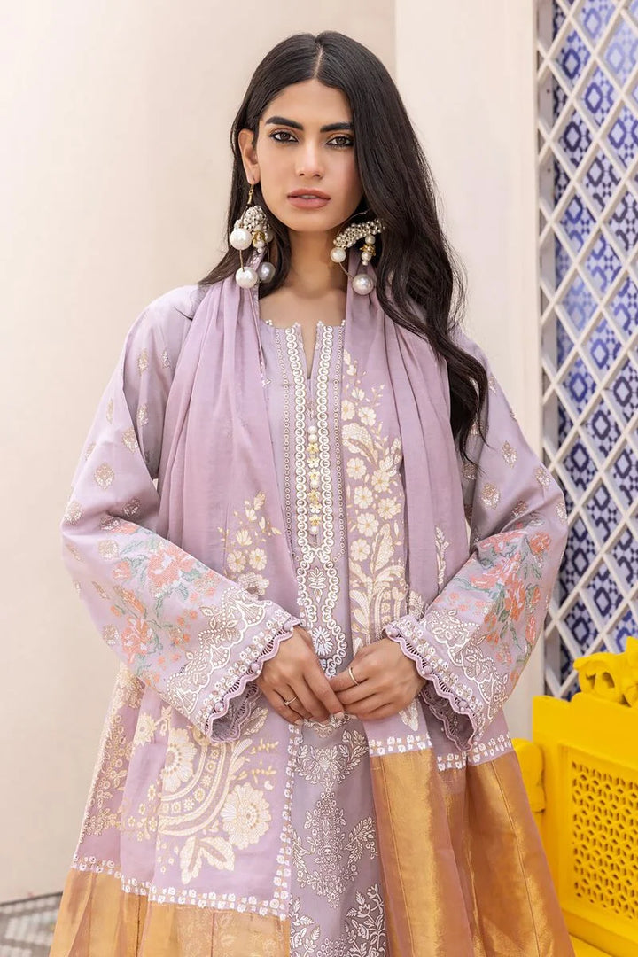pakistani outfits usa a woman wearing a purple and gold outfit