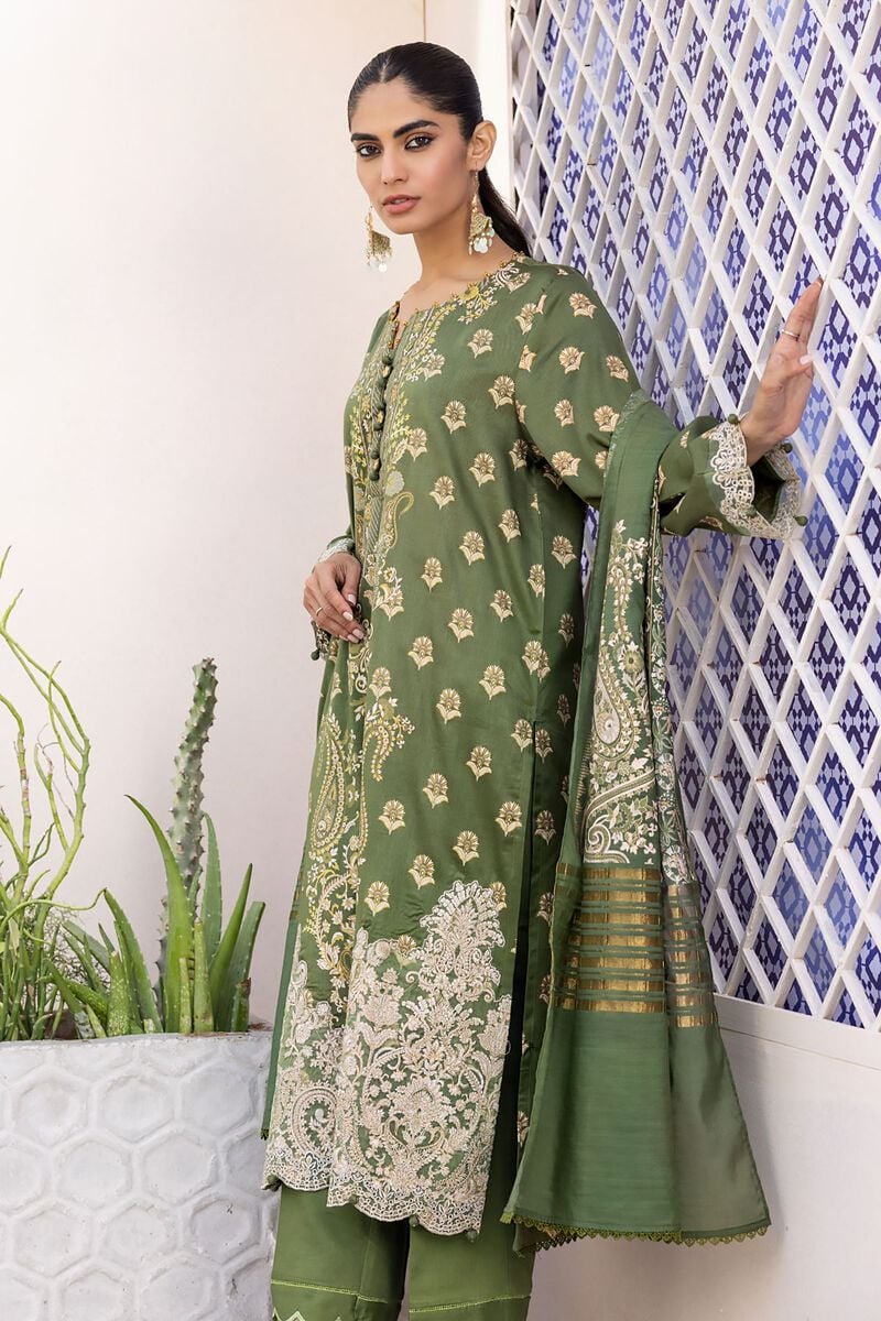 online shopping pakistani dress a woman in a green dress standing next to a wall