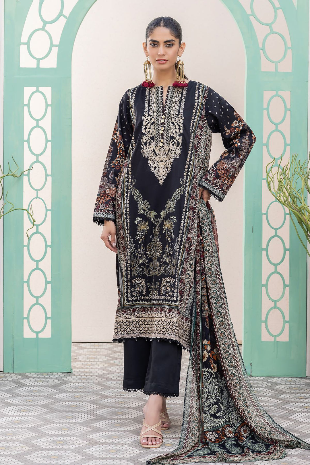 pakistani formal clothes a woman in a black and red dress standing in front of a wall