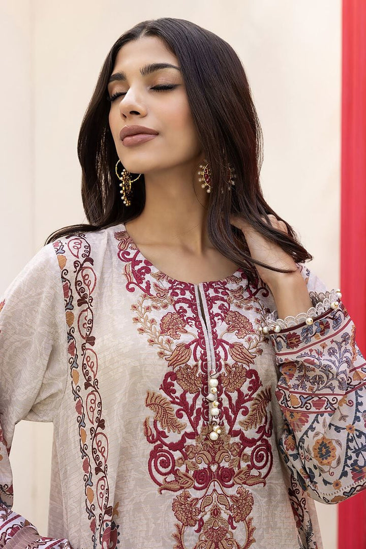Pakistani outfits a woman wearing a white and red shirt and gold earrings