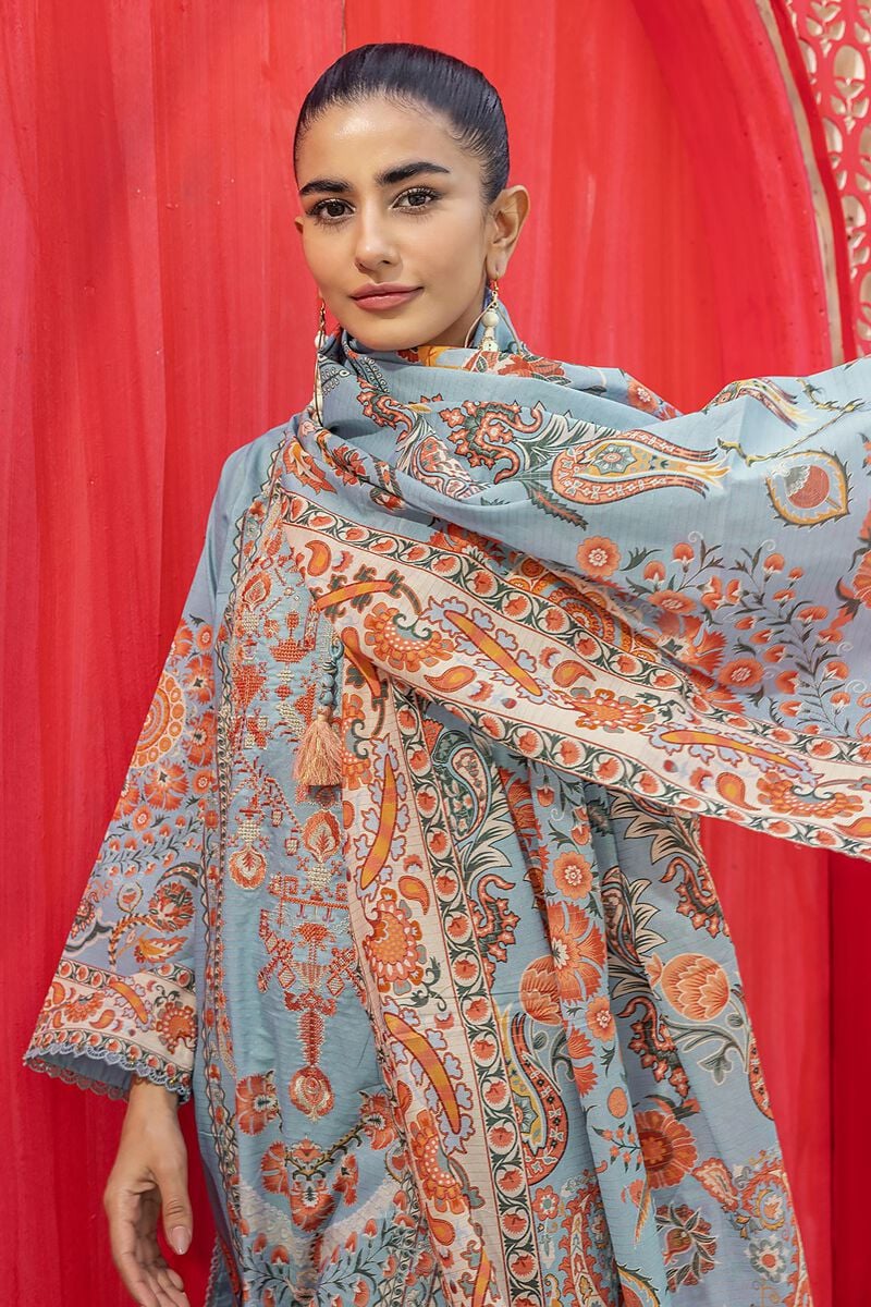 Online Pakistani Clothes a woman standing in front of a red curtain
