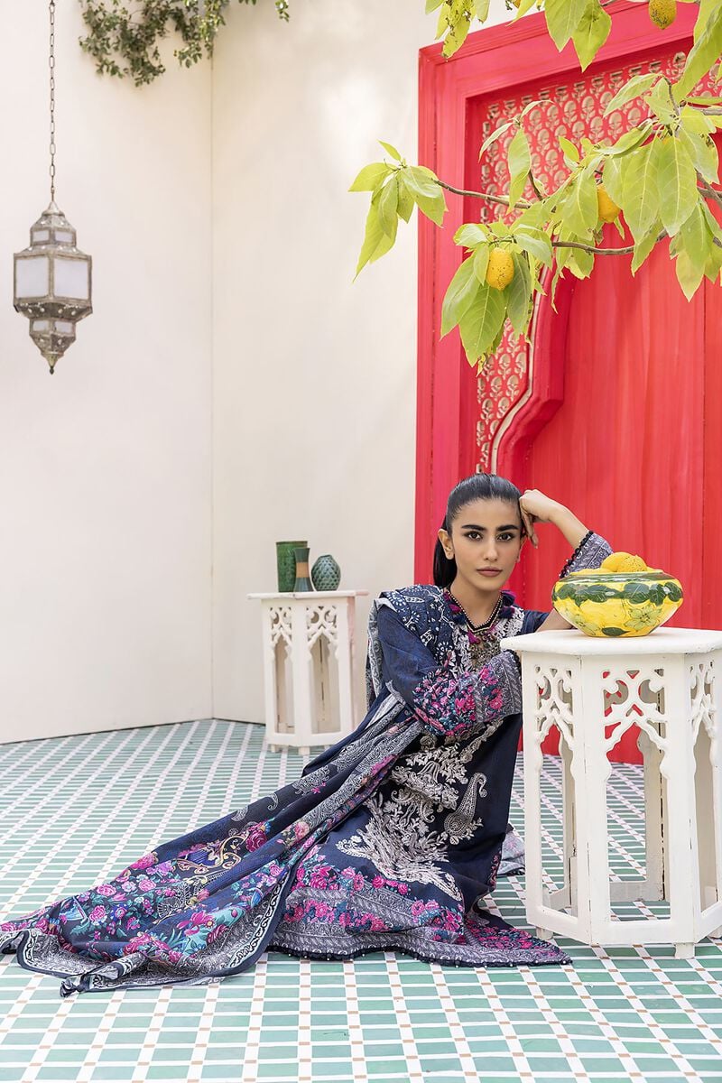 Pakistani Branded Clothes a woman sitting on the ground next to a table