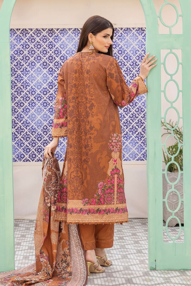 pakistani suits online a woman in a brown dress standing in front of a wall