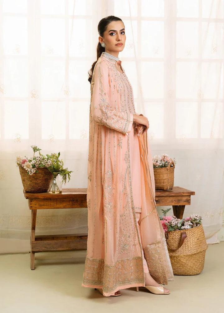 Side view of peach Pakistan gown dress woman with gold embroidery, shirt pants and dupatta for formal events.