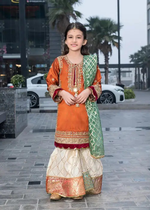 Rangreza Kid Gharara Dress in festive orange with embroidered raw silk shirt, jacquard lurex bottom, and green organza dupatta for girls.