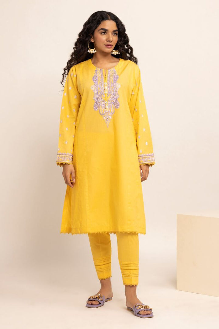 Authentic Pakistani Clothes Online a woman wearing a yellow tunic and pants