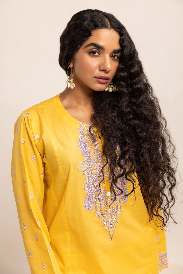 Authentic Pakistani Clothes Online a woman with long hair wearing a yellow top