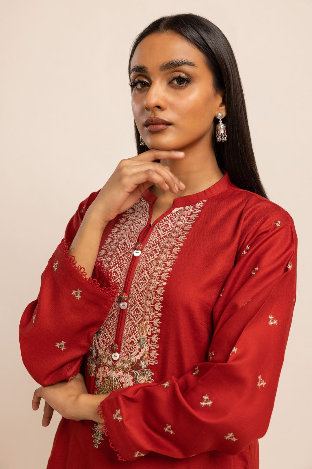 Khaadi USA pakistani suits online  a woman in a red dress posing for a picture