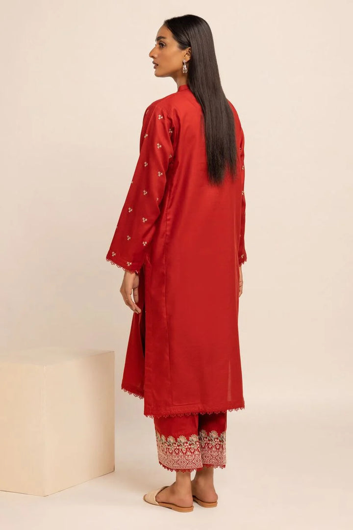 Khaadi USA pakistani suits online  a woman standing in front of a white background