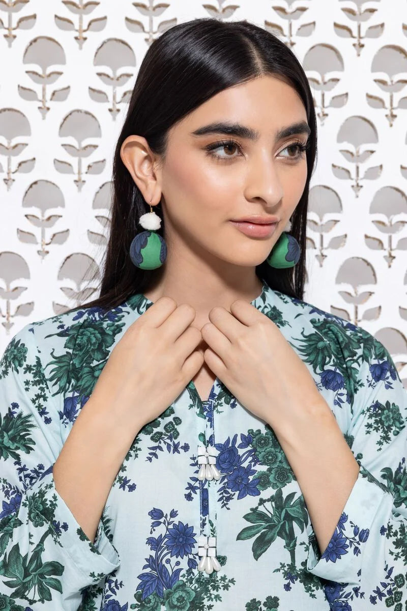 a khaadi  woman wearing green and white earrings