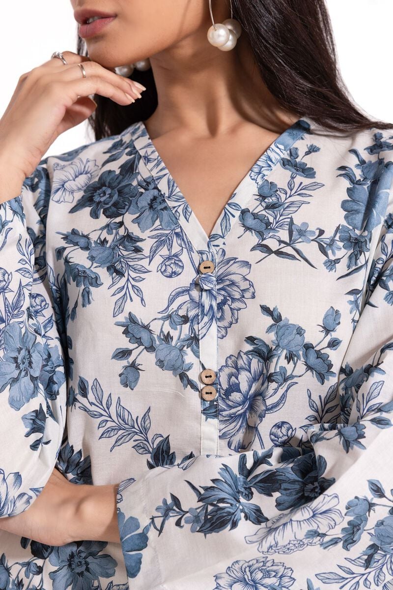 a Khaadi Design woman wearing a blue and white floral dress