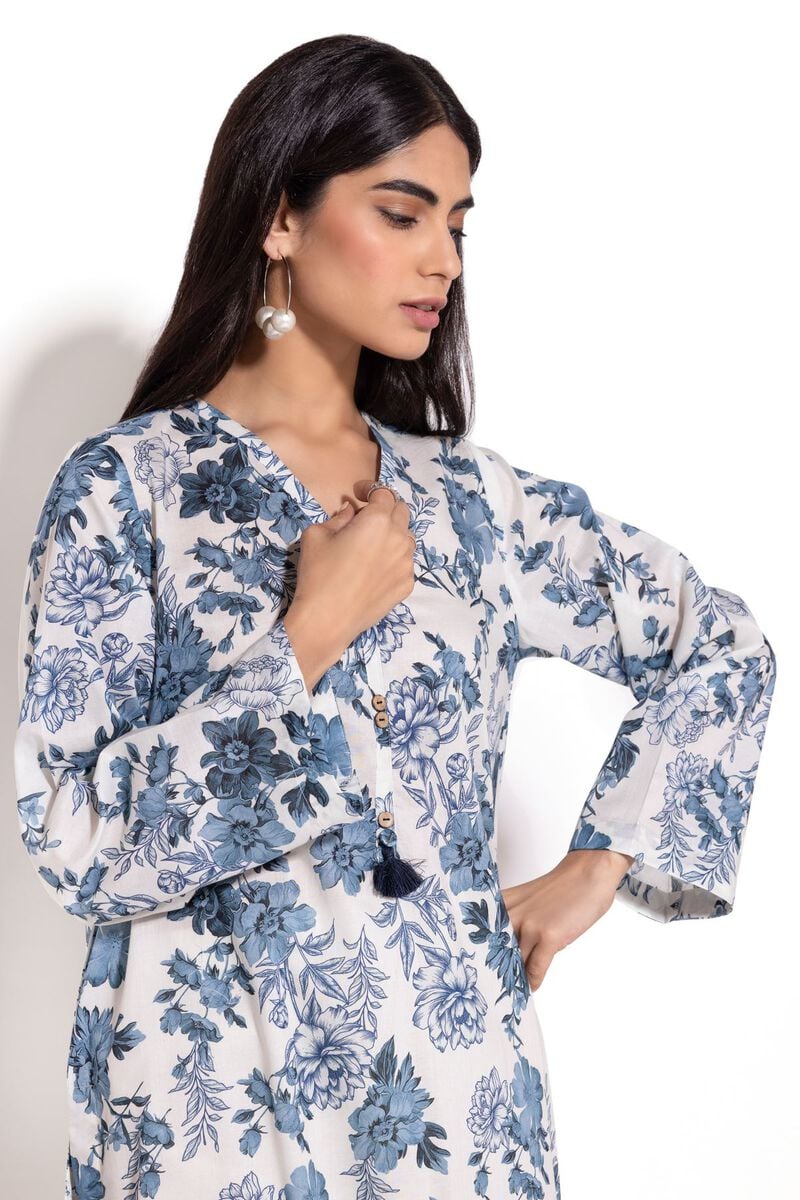 a Khaadi Design woman wearing a blue and white floral print dress