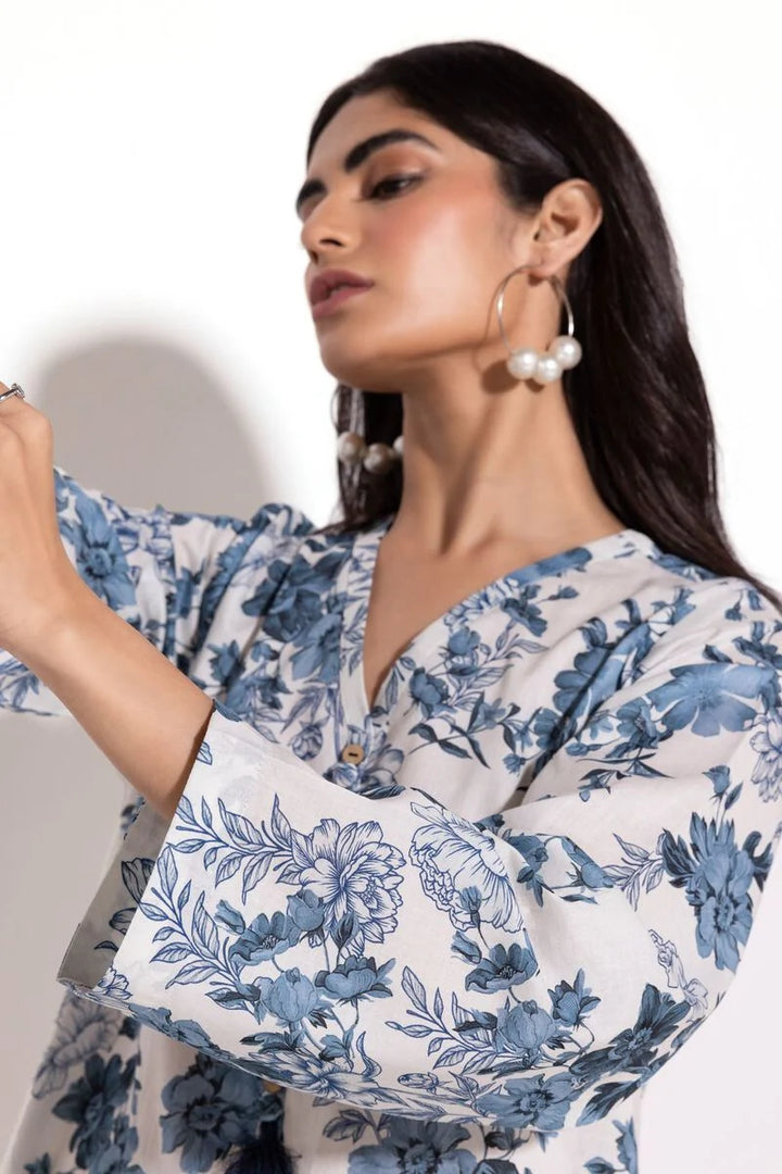 a Khaadi Design woman in a blue and white floral dress