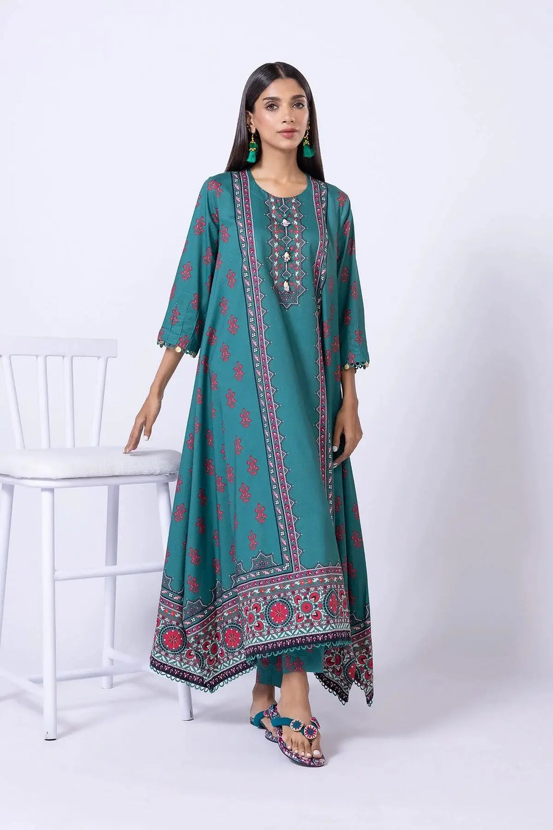 Full-length view of teal green Khaadi kurta EET24638A featuring red floral motifs, embroidered neckline, and asymmetrical hemline.