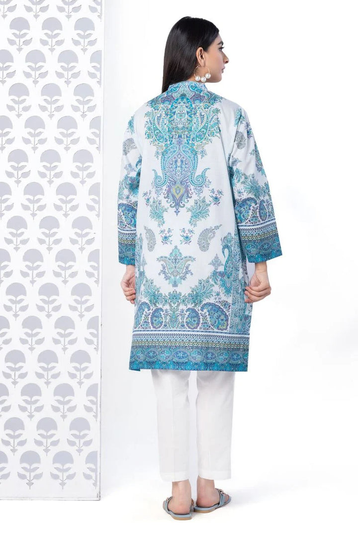 a KHAADI 1 piece SHIRT woman standing in front of a wall