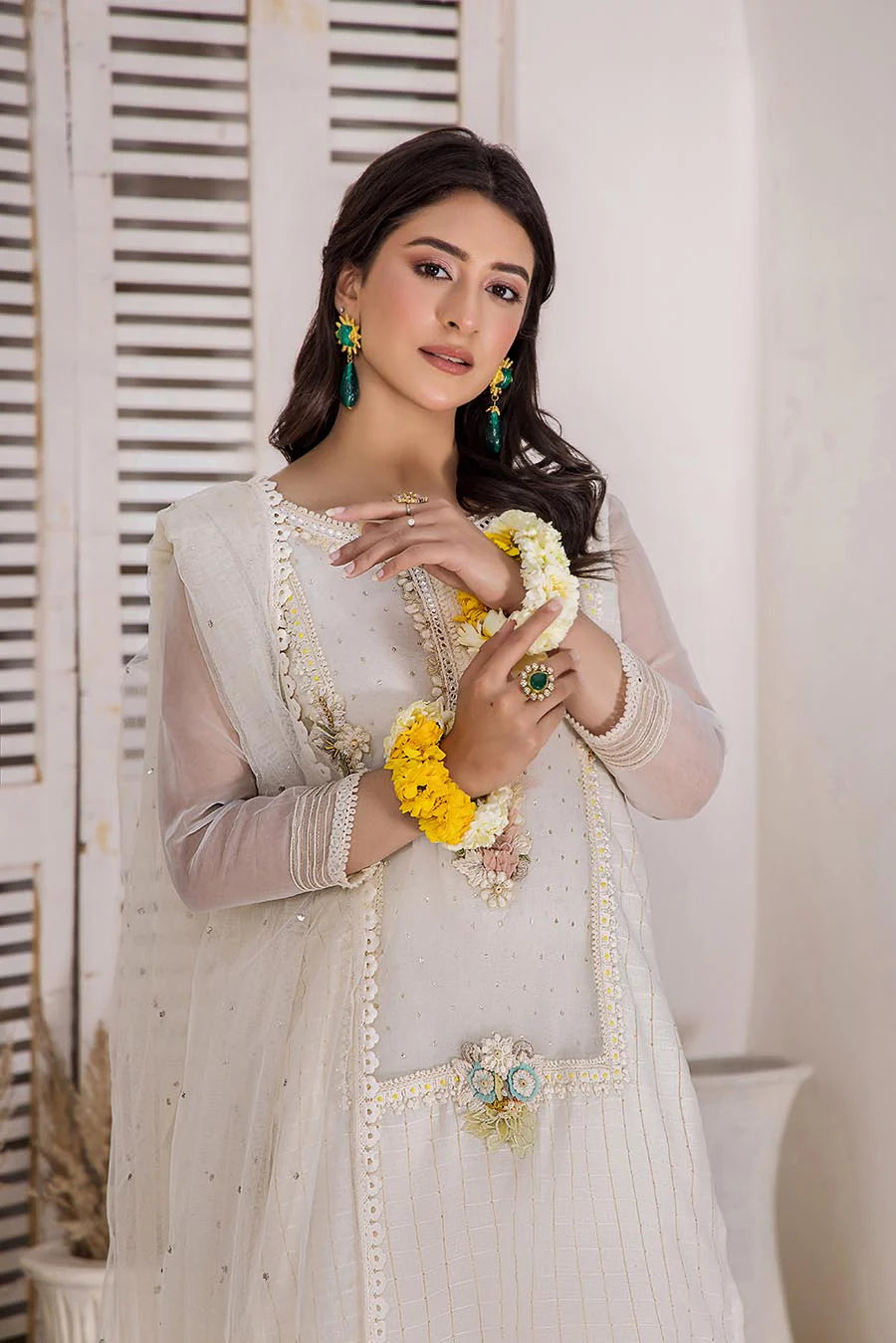 KHUDA BAKSH Ready To Wear woman in a white dress with yellow flowers